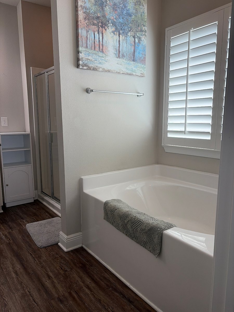 Master bath with glass walk in shower and garden tub