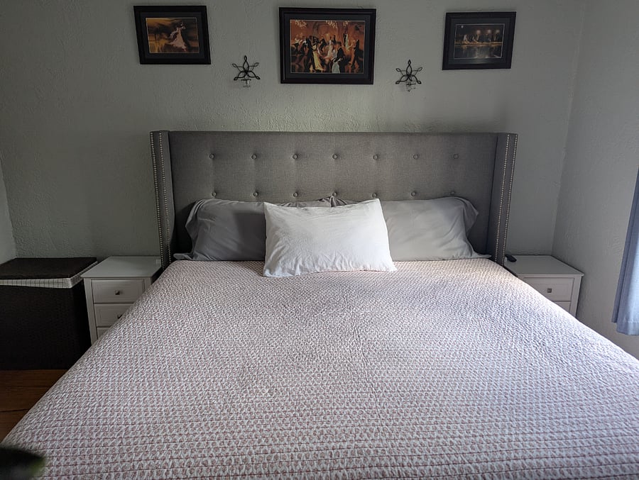 Main bedroom located on the back of the house. There is also a workspace for remote work.
