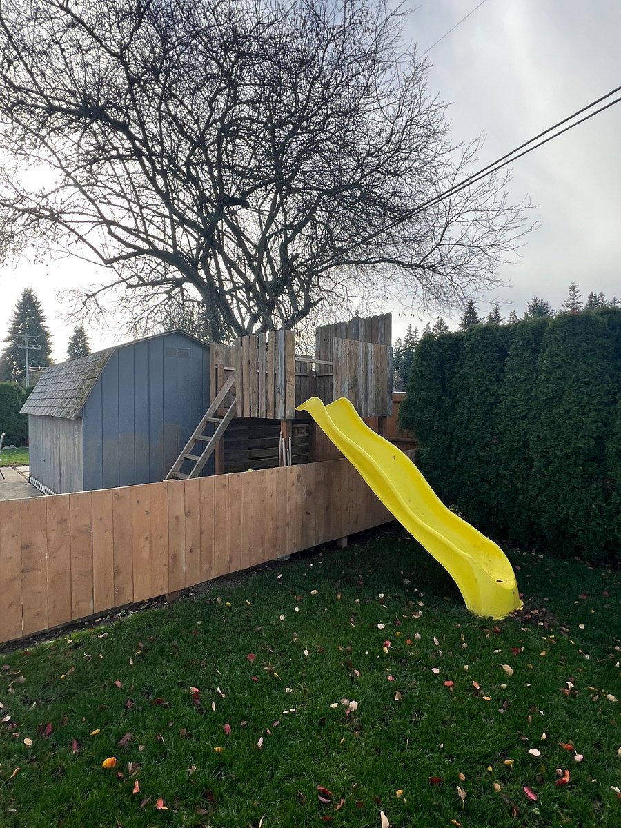 Treehouse with rope pully, slide, and mud kitchen below