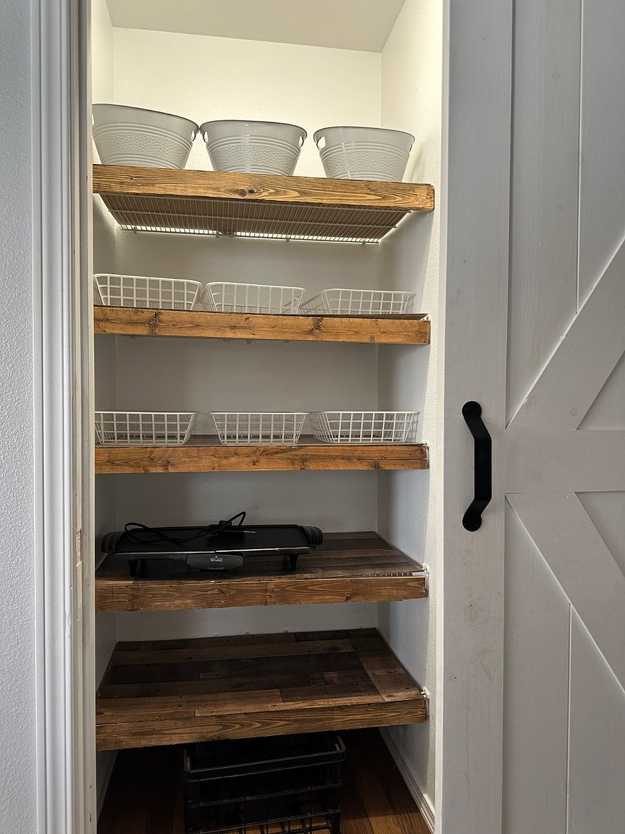 Barn door pantry including storage baskets for organizing groceries