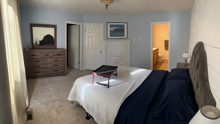 Downstairs primary. Closet door to the left, hallway door in the middle, and master bath door to the right.
