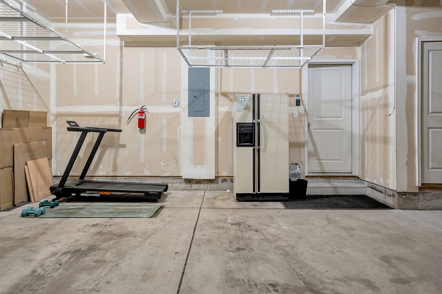2-car garage featuring a second fridge and treadmill
Safety features: Fire extinguisher