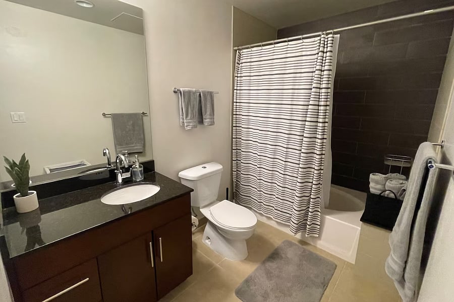 Condo Unit: Bathroom includes Toilet, Sink, and Bathtub with Dual Shower Heads