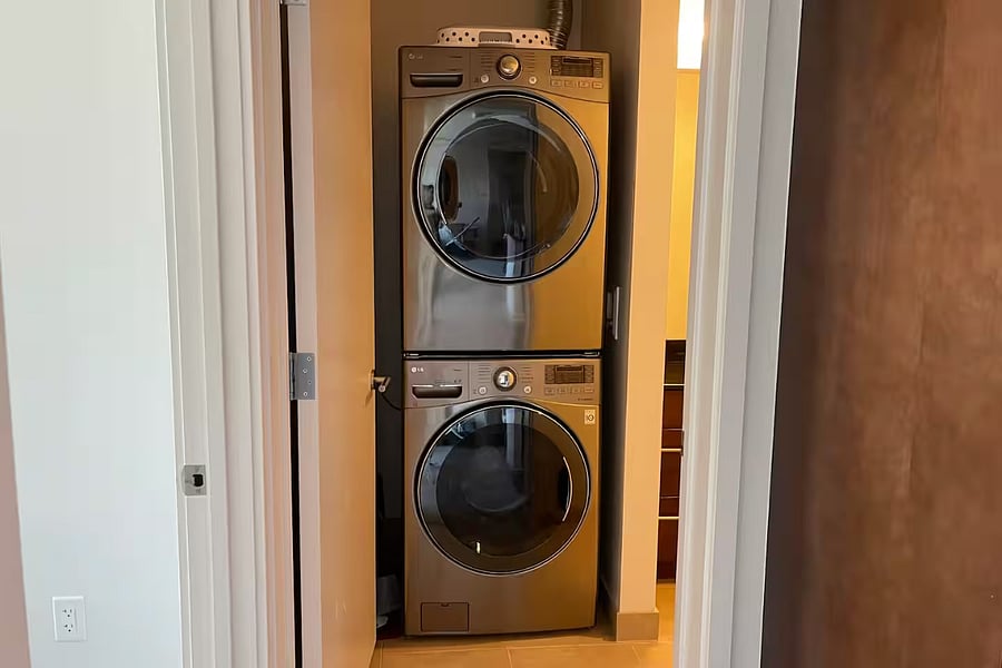 Condo Unit: Stacked Dryer and Washer within Bathroom