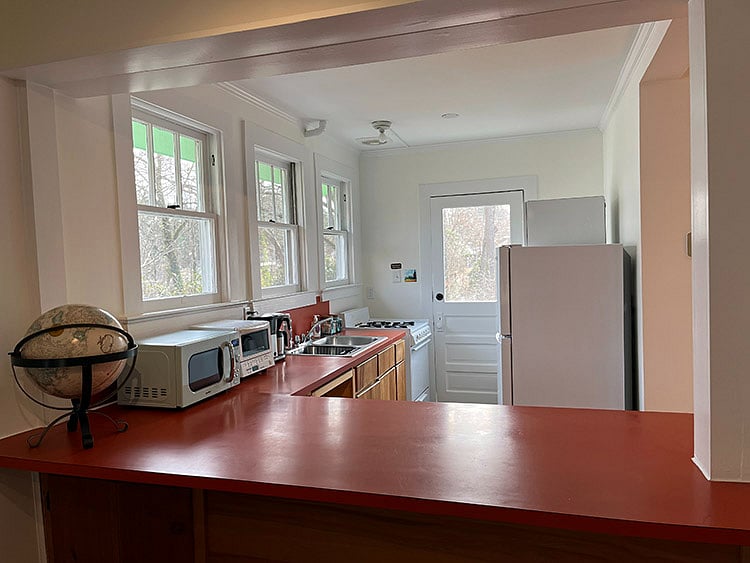 Kitchen washer/dryer is behind the fridge