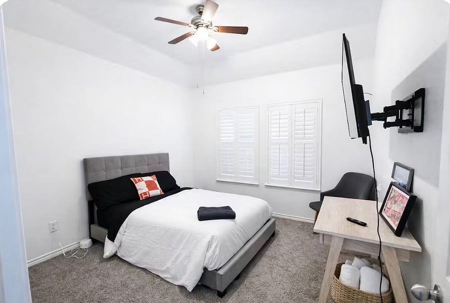 Second bedroom featuring a full-size bed that comfortably sleeps two, along with a TV for added comfort and relaxation.