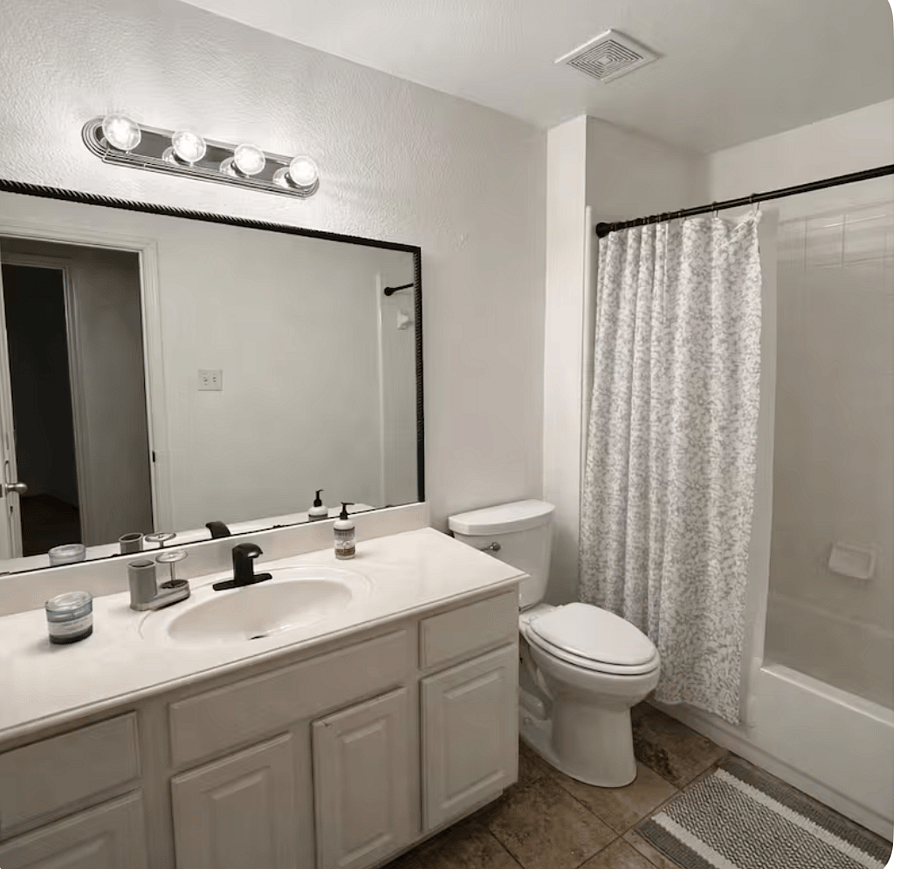 The second bathroom features a bathtub and a separate standing shower, offering flexibility and convenience for guests.