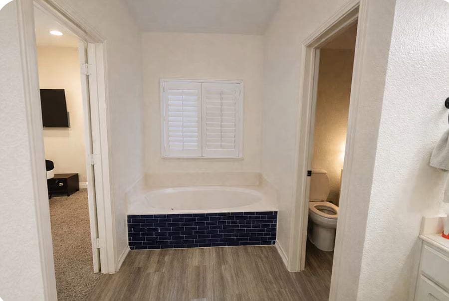 The main bathroom features a spacious double vanity and a relaxing bathtub, perfect for unwinding after a long day.