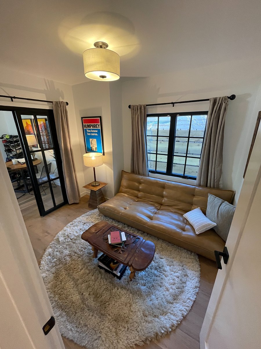 Second bedroom with leather couch that folds down into a bed; currently used as reading room.