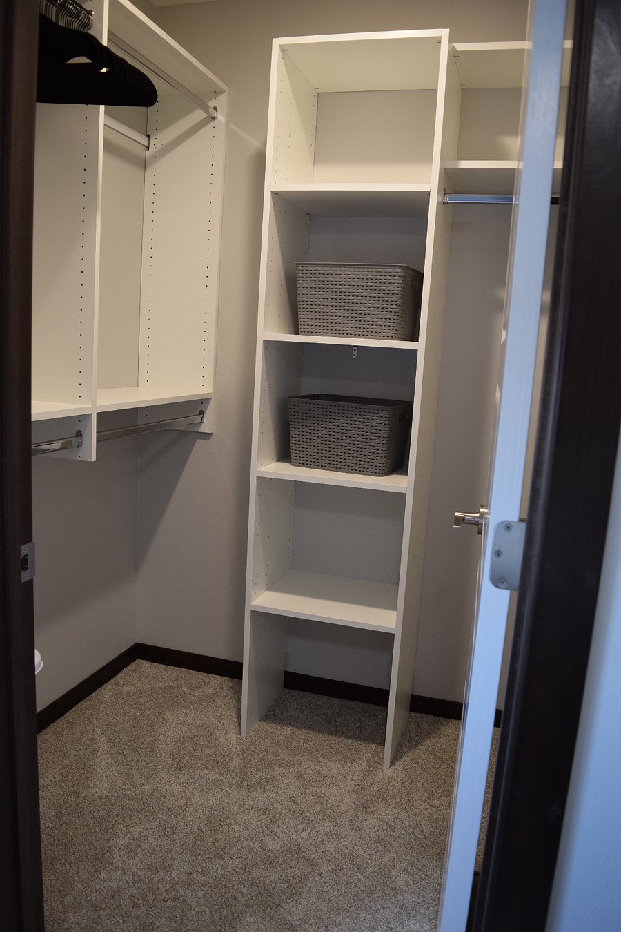 Bedroom 1 walk-in closet with lots of closet bars and shelving.