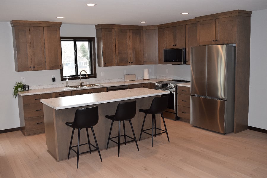 
kitchen with all appliances and three seats at the island.