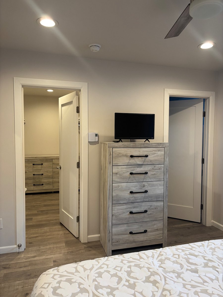 Walk-in closet with laundry (left) & bathroom located in master bedroom (right)