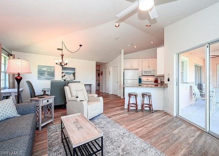 Light and Bright Great Room with Soaring Ceilings overlooking the Golf Course - leads out to the screened in lanai