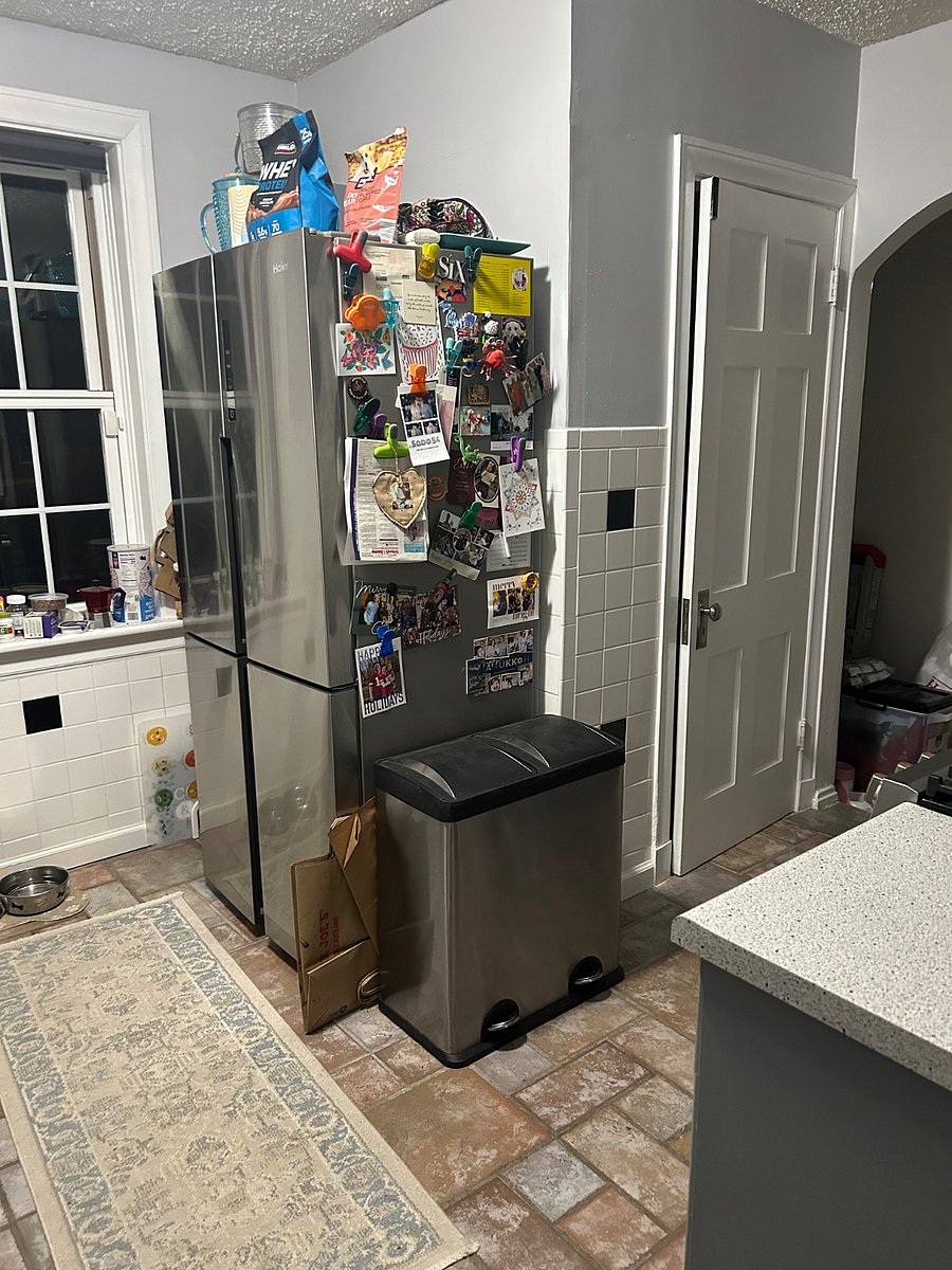 Kitchen with half bathroom and basement access.