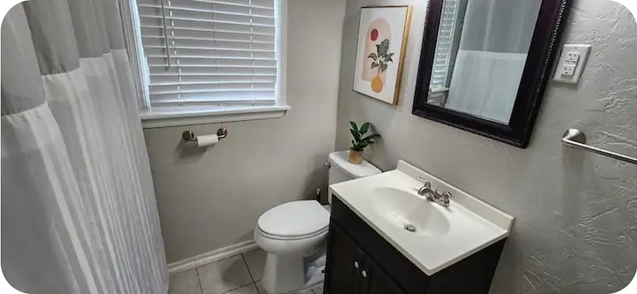 At the center of the home, there is a full bathroom with sink, toilet, tub, and shower. the tub has railings for easy entering and exiting a nice hot bath. The bathroom is located down the hall and the first door to the right.