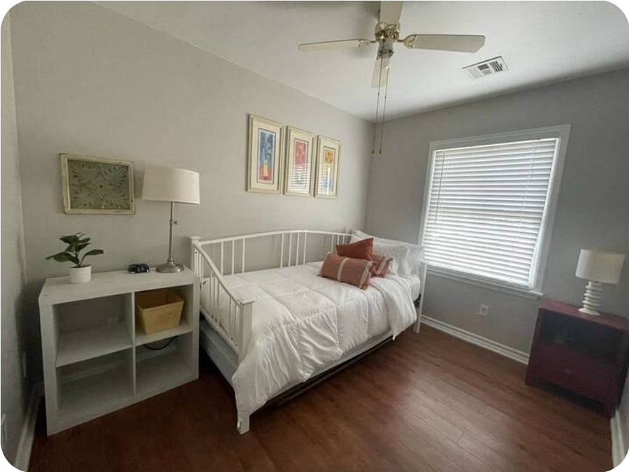 This bedroom has a fun colorful theme with a day bed. There's also a trundle bed that rolls out and pops up, sleeping an additional guest! Included in this space is a private closet. This room is located down the hall and the first door to the left.