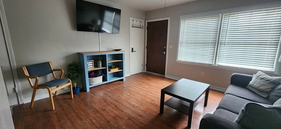 There is additional seating in the living room that can be move and turned to face a 55 Inch Smart TV.