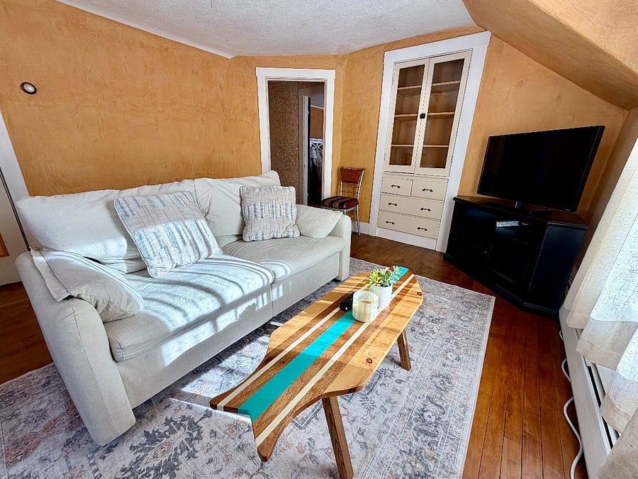 Warm and cozy living room with TV, Couch, armchair, coffee table