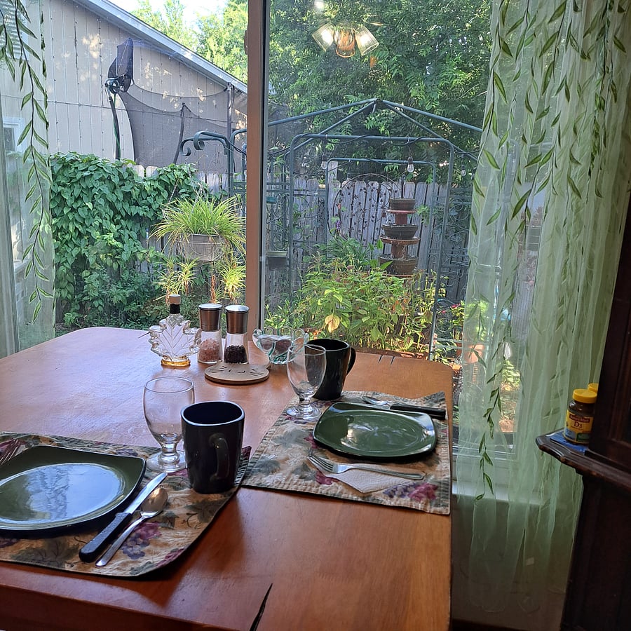 The dining table looks out to the "Kitty Garden Fountain" and is also wonderful for bird watching.