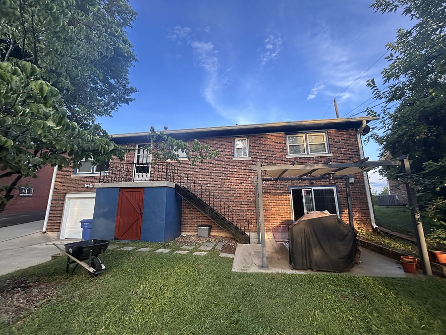 Backyard includes a patio with gazebo and grill