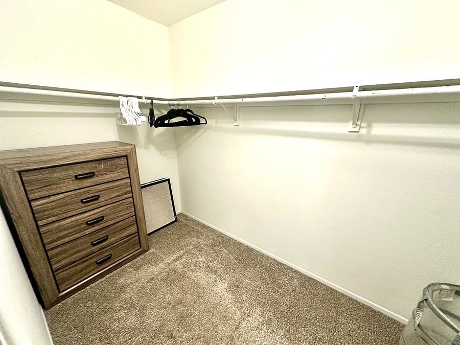 Master bed walk in closet POV 1