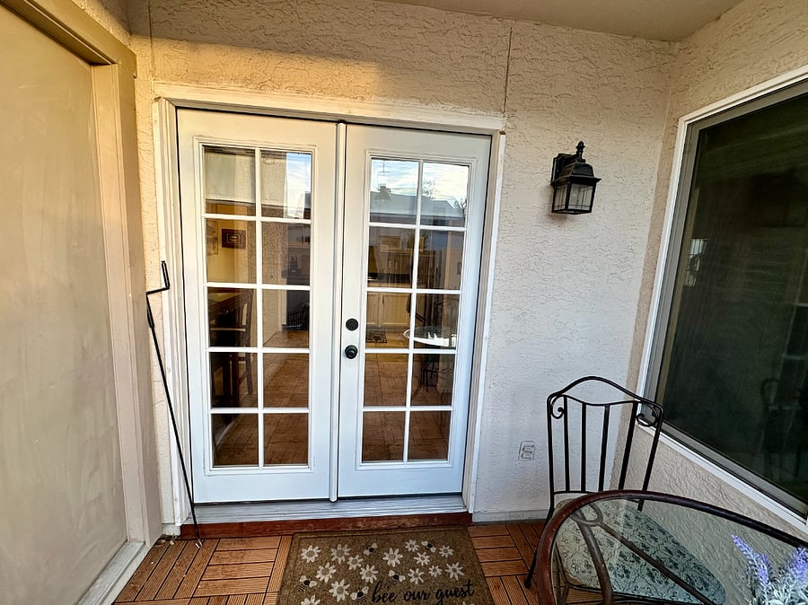 French doors open up to the patio outside and kitchen and dining inside