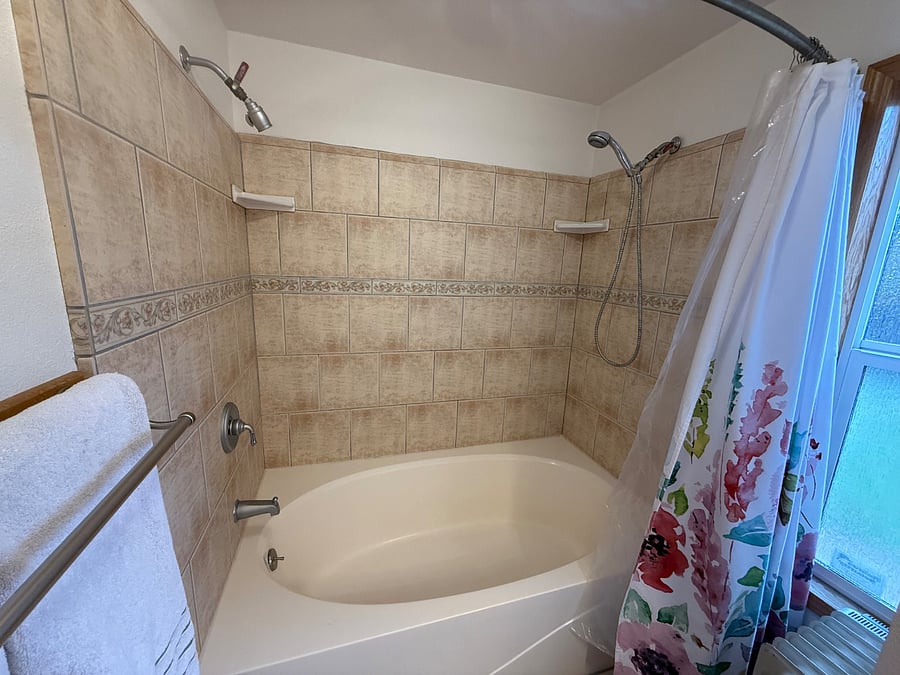 Soaking tub with two shower heads.