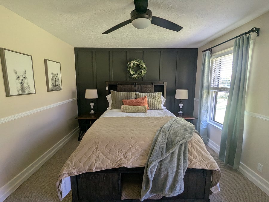 The second bedroom features a solid queen bed with storage and blackout curtains