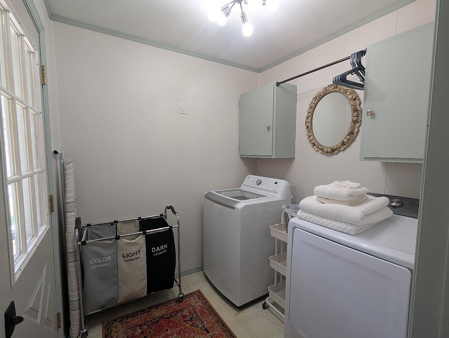 A laundry hanging area, clothes separator and ironing board and iron are all included. 