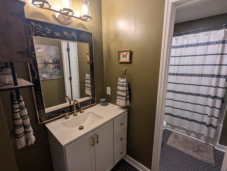 The main floor bath sits between the 2 additional bedrooms on the opposite side of the house from the master suite