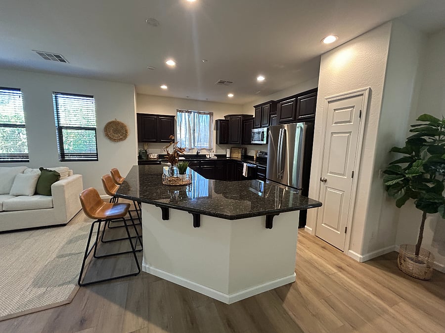 Full kitchen with stainless steel appliances, and large island for entertaining. Dishes/cutlery and coffee machine included.