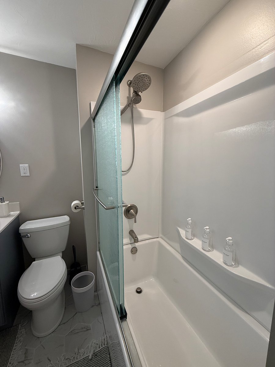 Private bathroom with tub and shower