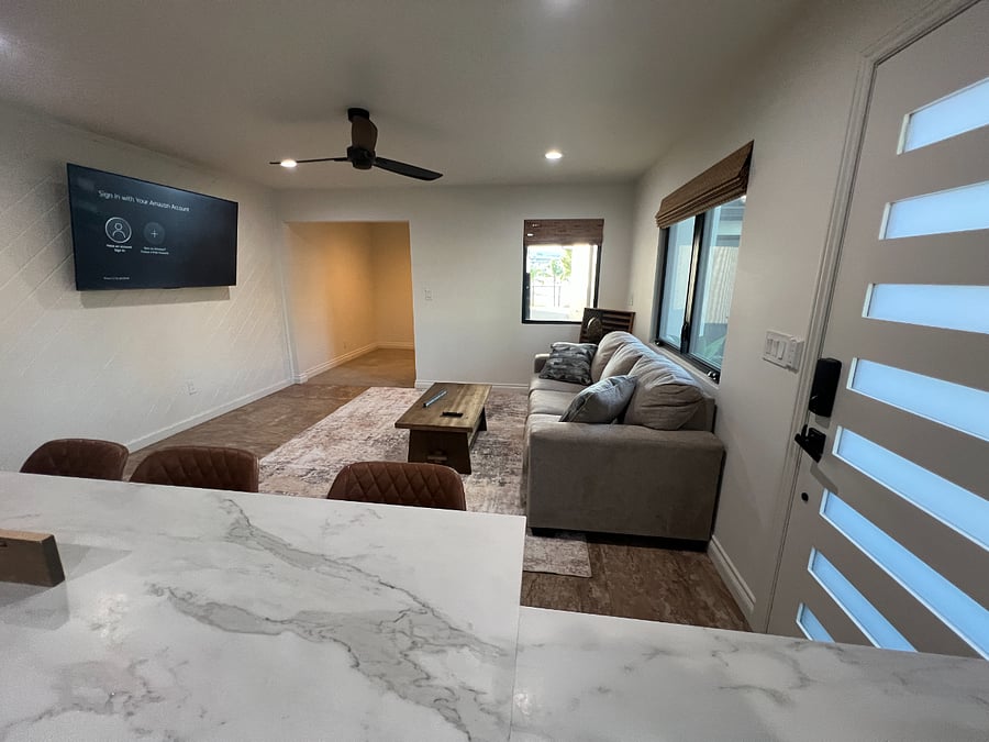 Living room area with a glimpse of the office/den