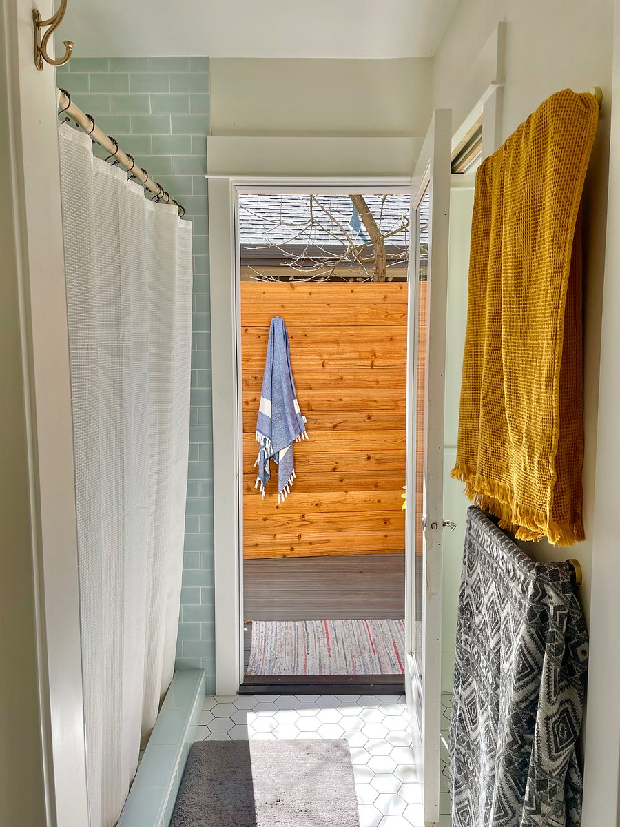 Primary bath leading to the outside secret garden and shower