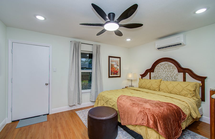 Door opens to back porch with utility room and enclosed private backyard