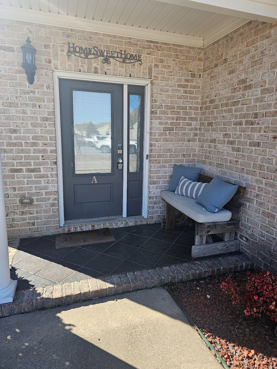 Front door with electronic lock and comfortable seating area. 