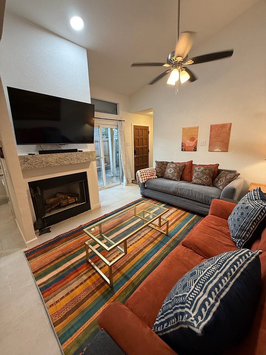 Living room with queen sized sleeper sofa and end tables, regular sofa, corner table and lamp
