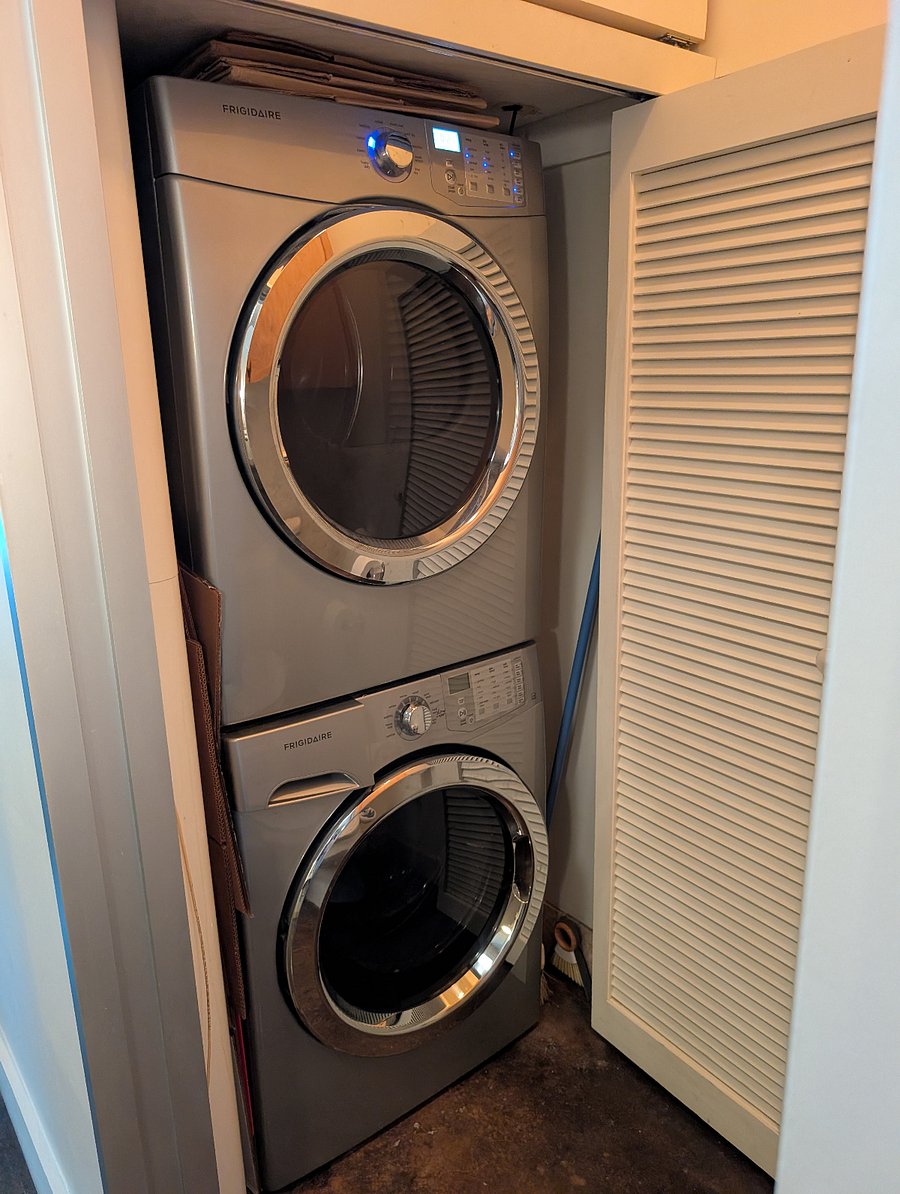 stacked full sized washer and dryer in unit