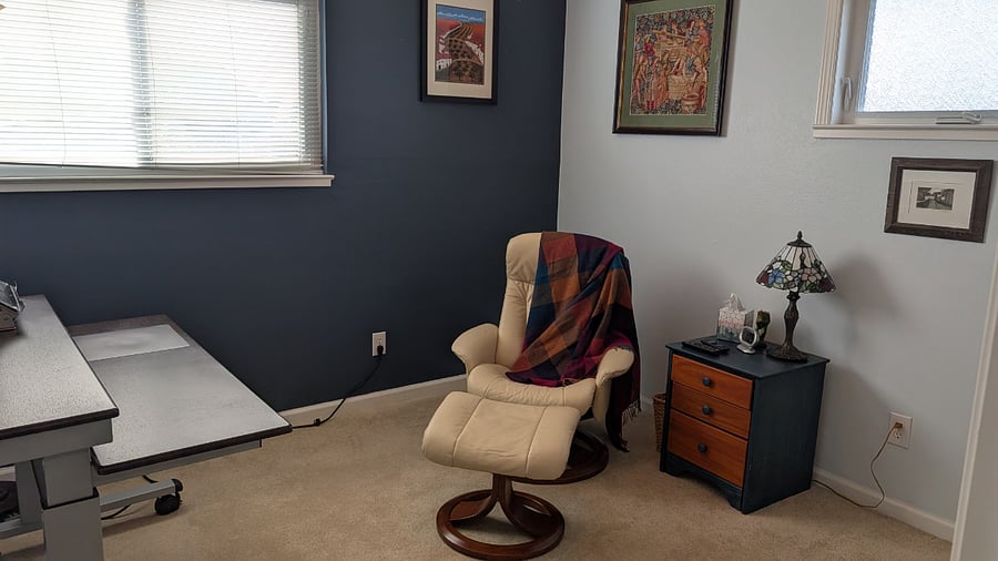 Sitting room with TV, desk, and closet.