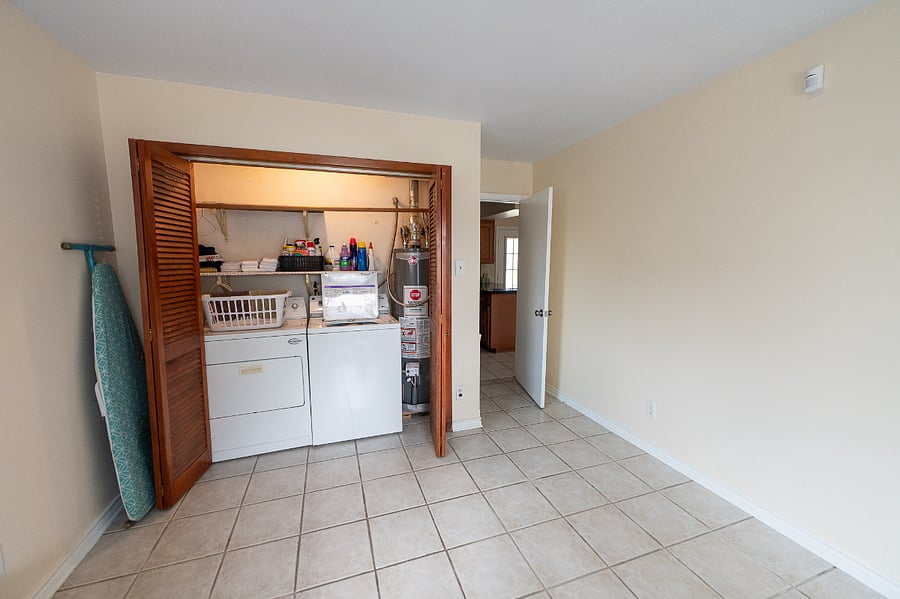 Shared Laundry area - cleaning supplies and First Aid Kit on top shelf