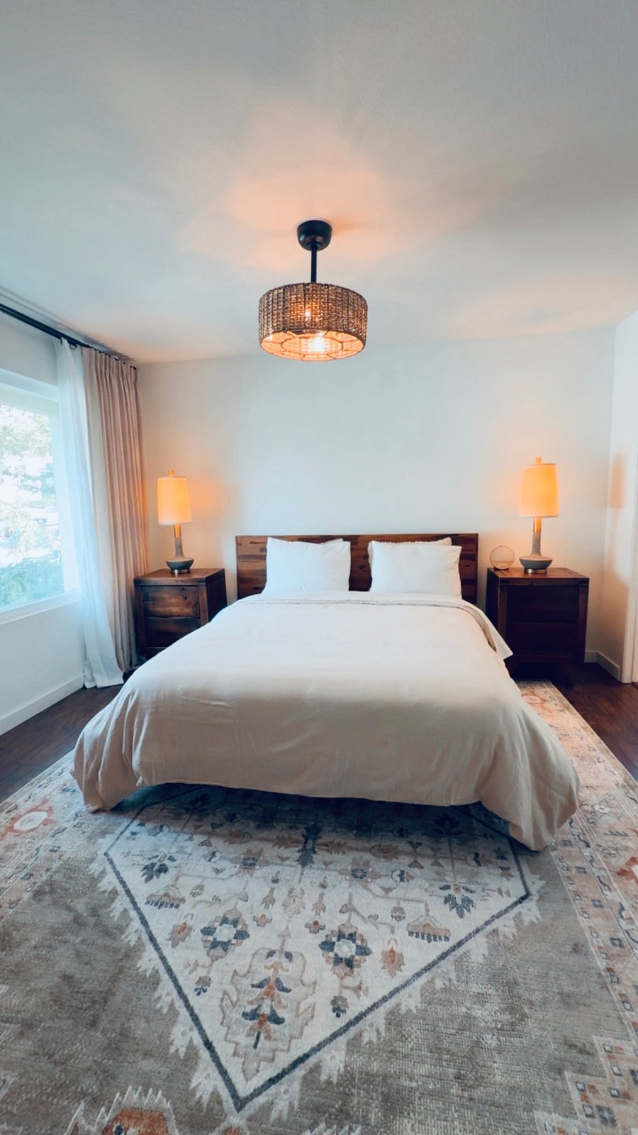 Peaceful master bedroom featuring soft linens, blackout curtains, and a comfortable bed for restful nights.