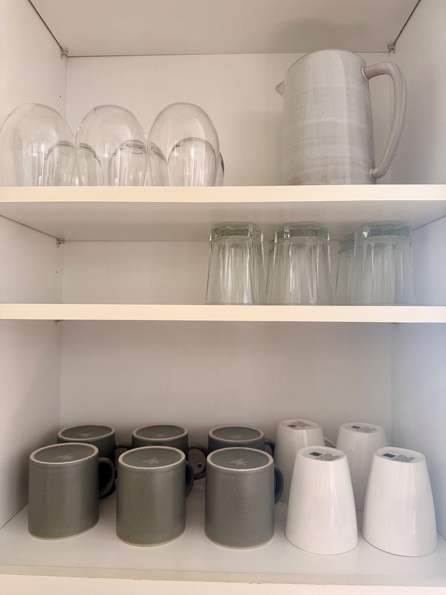 Plenty of glassware and coffee mugs ready for morning coffee or evening drinks.