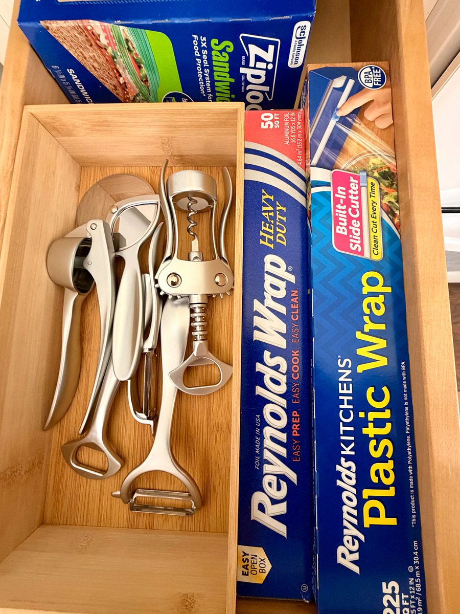 Kitchen essentials including bottle opener, foil, plastic wrap, and storage bags for added convenience.