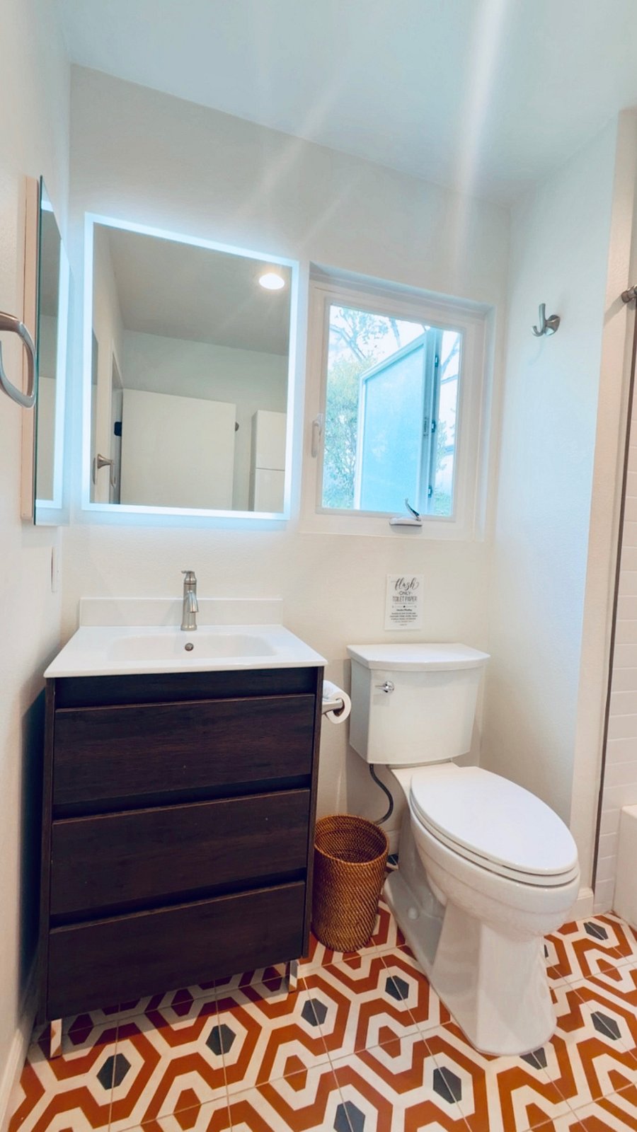 Clean, modern bathroom with bright vanity lighting and fresh, updated finishes.