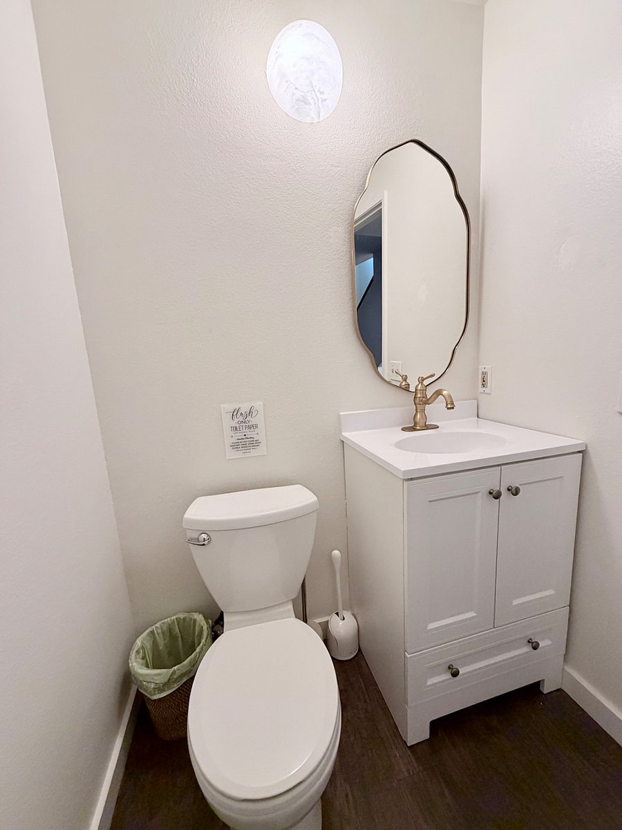 Third bathroom.  Half bathroom downstairs with modern fixtures and clean, simple design.