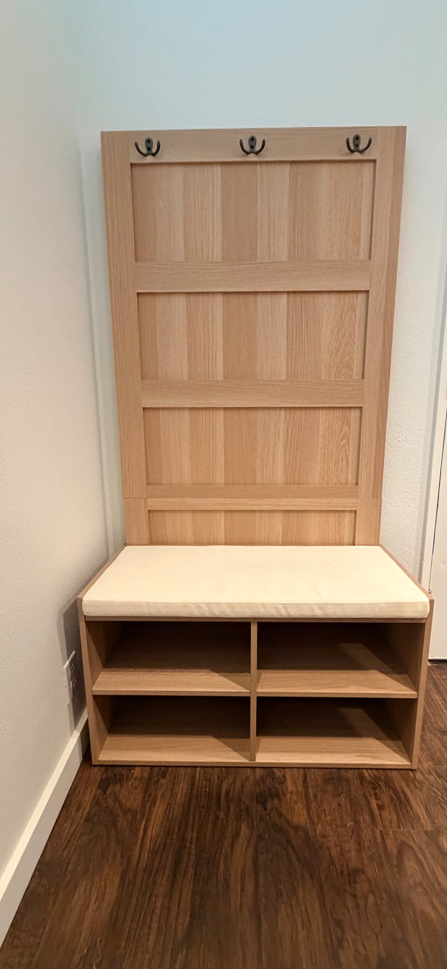 Functional entry area with bench seating and shoe storage for added convenience.