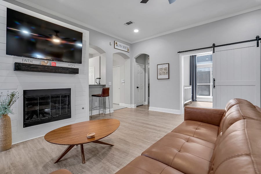 View of living room with large fireplace, Smart Google TV and 2nd workspace, open to flex room and kitchen