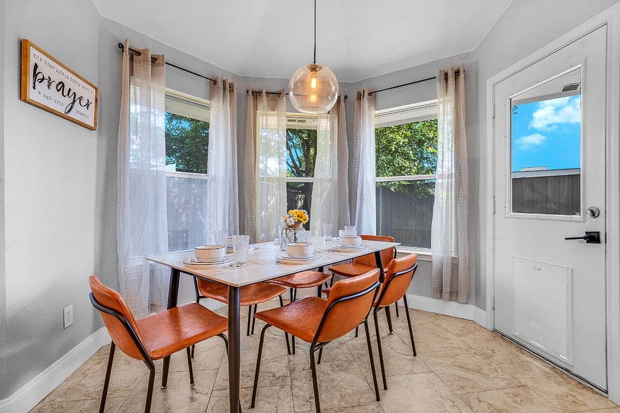 Dining area for six with windows overlooking the backyard