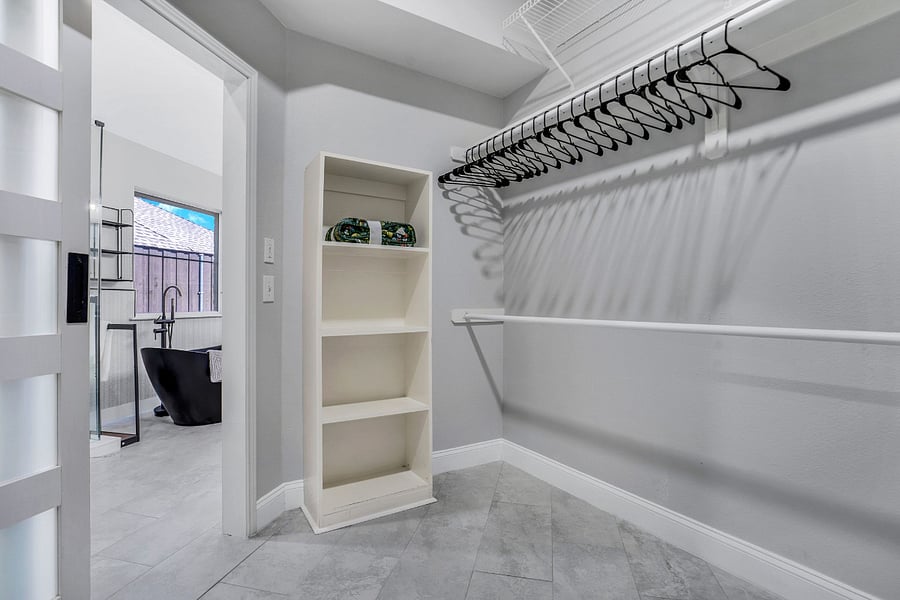Accessible from the primary bathroom, a large walk in closet and dressing room with barn doors