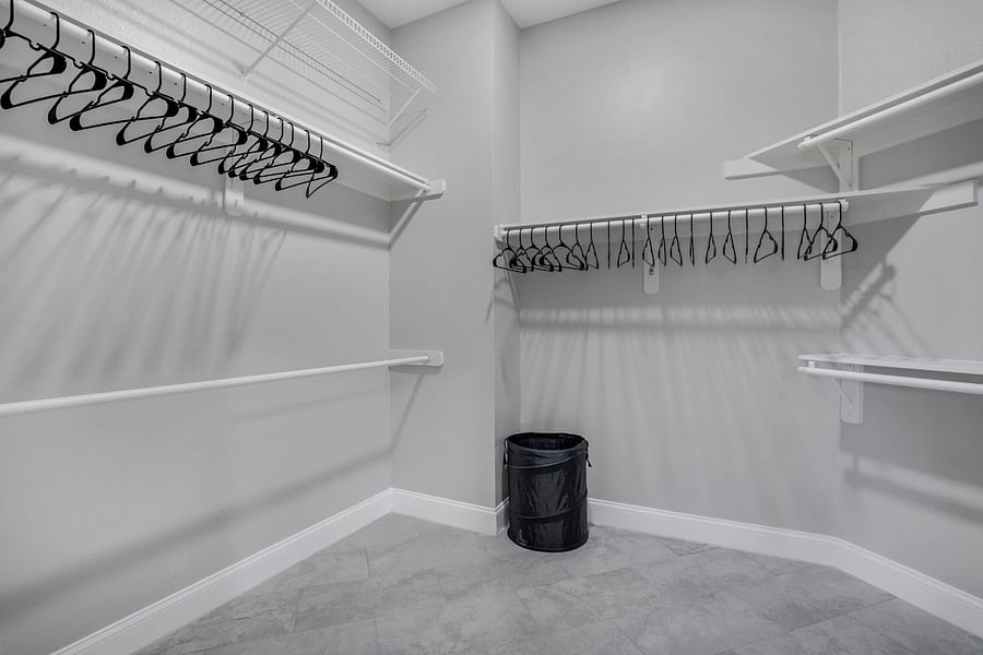Accessible from the primary bathroom, a large walk in closet and dressing room with barn doors